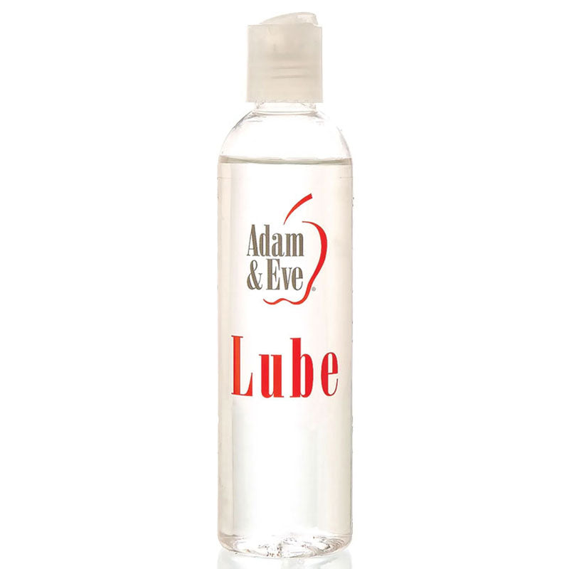 The Adam & Eve Lube is a water-based lubricant housed in a clear plastic bottle with a flip-top cap. The bottle, containing transparent liquid, displays an apple outline around the brand name against a plain white background. It holds 237 ml (8 oz) of sensual lubricant.