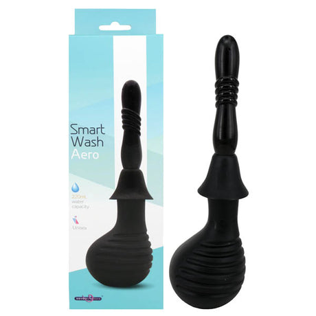 The image displays the Smart Wash - Aero black enema bulb with a ribbed nozzle, next to its predominantly white box with teal accents, showcasing the 220 ml capacity. The packaging highlights that its phthalate-free and suitable for all genders.