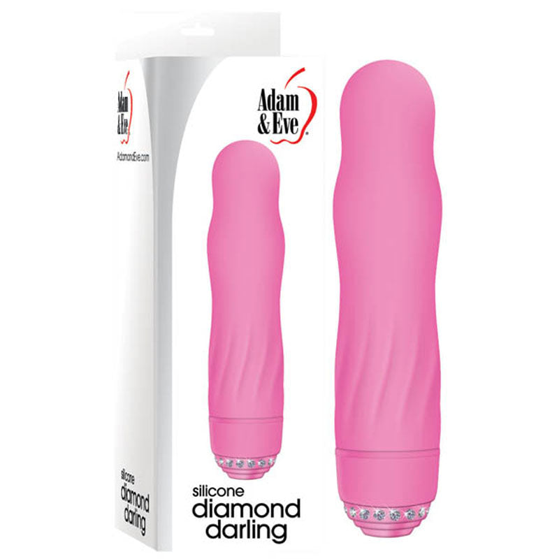 The Adam & Eve Diamond Darling - Pink 10.25 cm Vibrator features a smooth, curved design with a ribbed surface and powerful speeds. The base, adorned with clear faux diamonds, sits beside its packaging displaying the product and brand name Adam & Eve.