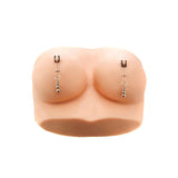 The Adam & Eve Eves Naughty Nipple Clips feature realistic silicone, skin-toned breast models with metallic nipple rings and beads against a white backdrop, ideal for enhancing kinky couples play or exploring adjustable clamps.