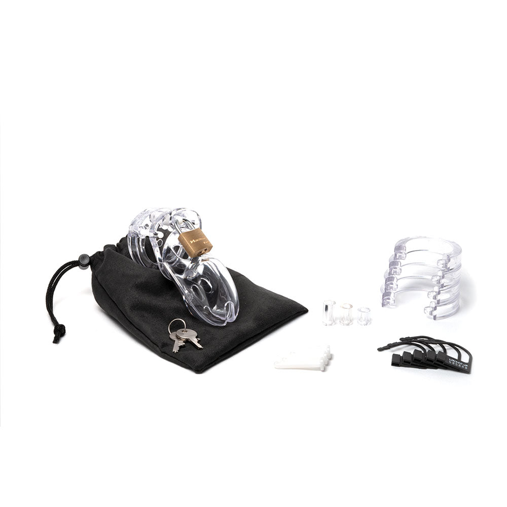 The image showcases a CB-3000 Chastity Cock Cage Kit, featuring a clear 3-inch cage with padlock, keys, and adjustable resizing rings. It includes a black drawstring pouch, two clear spacers, and several black locking pins on a white backdrop.