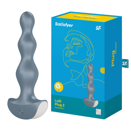 The Satisfyer Lolli-Plug 2 - Gray Vibrating Anal Beads, crafted from body-friendly silicone, sports a design with three rounded bulbs and a wide base for ultimate anal pleasure. Its teal packaging with yellow accents features a minimalist line drawing of a face alongside the product image.