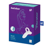 The image shows a blue box with purple accents for the Satisfyer Bold Lover - White USB Rechargeable Finger Stimulator, featuring a womans outline. It contains a white finger vibe made from body-safe silicone, emphasizes 15 settings, and promises targeted stimulation.