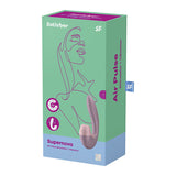 The image displays the packaging for the Satisfyer Supernova - Old Rose USB Rechargeable Vibrator with Air Pulsation, crafted from body-safe silicone. The green box with a purple top features a line drawing of a womans face and showcases product images and functions on the front.