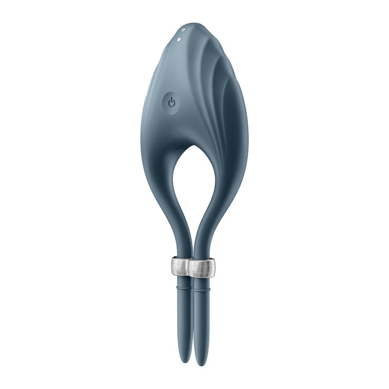 The Satisfyer Duelist is a dark blue, leaf-shaped, silicone device with a circular power button and hollow center. It has two slim extensions at the bottom, encircled by a metallic band, featuring textured ridges on top for a modern and sleek design.