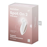 The white Satisfyer Spot On 2 USB Rechargeable Stimulator box features a product image cutout, branding, and product details. Text highlights its elegant design, powerful motor, targeted clitoral stimulation, and 15-year warranty. Made from body-safe silicone.