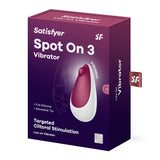 The purple box with white text unveils the Satisfyer Spot On 3 - Berry USB Rechargeable Stimulator, featuring a silicone vibrator in white and burgundy for targeted clitoral stimulation, complete with a moveable tip and waterproof design. Branding elements are prominently displayed.