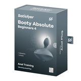 The Satisfyer Booty Absolute Beginners 4 - Grey comes in a dark box with bold white text, showcasing its unisex design and silicone build. It features Anal Training labels and an impressive 15 Year Warranty.