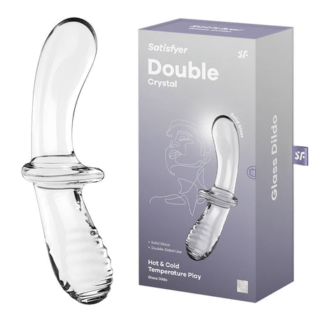 The image features the Satisfyer Double Crystal, a clear glass double-ended dildo with a curved design and textured grip. Its shown alongside its grey packaging box displaying images, text, and mentions of Hot & Cold Temperature Play features.