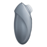 The Satisfyer Tap & Climax 1 is a sleek, ergonomic bluegrey lay-on vibrator with smooth curves, a small circular opening at the top, and a metallic side accent. Its handheld shape ensures comfort and ease of use for clitoral stimulation. USB rechargeable for convenience.