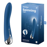 The sleek Satisfyer Spinning Vibe 1, a blue USB rechargeable vibrator with a rotating shaft and silver base, is shown beside its box. The blue packaging features white text reading Satisfyer Spinning Vibe 1 and highlights the waterproof, vibrating silicone design with illustrations and icons.