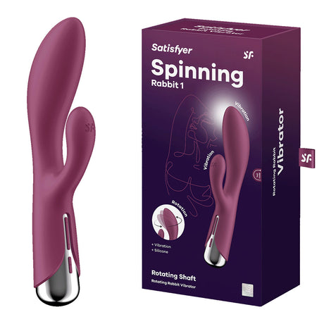 A red Satisfyer Spinning Rabbit 1 vibrator is shown next to its box, featuring a curved design and a smaller appendage. The packaging highlights vibration and rotation functions such as Rotating Shaft and Vibrations in white text on a dark purple background.