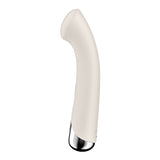 The Satisfyer Spinning G-Spot 1 in beige is a USB rechargeable, 16.5 cm curved vibrator with a smooth texture, metallic base, and minimalist design. Its waterproof and rotates for optimal G-spot stimulation against a plain white background.