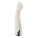 The Satisfyer Spinning G-Spot 1 in beige is a sleek, cream-colored vibrator with a shiny metallic base. Its smooth, elongated shape features a slight bend and an indent near the top, with control buttons on the metallic part for easy access to intense vibration modes.