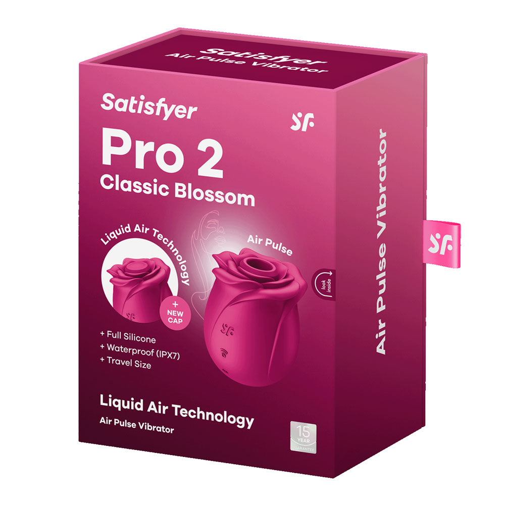 The image shows the packaging of the Satisfyer Pro 2 Classic Blossom, highlighting its red rose-shaped Air Pulse Stimulator. The pink box emphasizes Full Silicone, Waterproof (IPX7), and includes a travel case, showcasing innovative features.