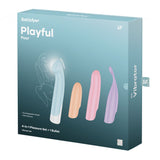 The Satisfyer Playful Four set features a USB rechargeable vibrator with 4 interchangeable heads in pastel shades: blue, pink, purple, and light purple. The packaging includes options for G-spot exploration and displays a womans graceful silhouette in line art.