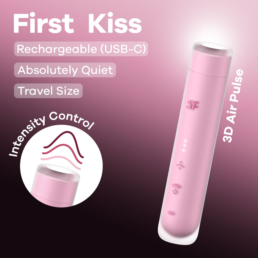 The Satisfyer First Kiss - Pink USB Rechargeable Air Pulse Stimulator is a pink cylindrical device featuring Rechargeable (USB-C), Absolutely Quiet, and Travel Size labels, with silicone layer, intensity control, 3D air pulse system, pressure wave intensities, and three button symbols on a pink gradient background.