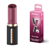 The image displays the Satisfyer Pro 2 Kiss in red/black, an air pulse stimulator for sexual wellness, beside its matching box. Pressure wave controls appear on the black part of the device. The packaging highlights USB-C Rechargeable and Travel Size, offering a glimpse of the product.