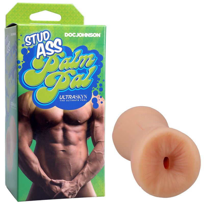 The Stud Ass Palm Pal UltraSkyn Stroker - Flesh Ass Masturbator box displays a shirtless male and flesh-colored stroker, featuring ULTRASKYN material for realism and a textured, lifelike interior. The design includes green with blue and yellow text.