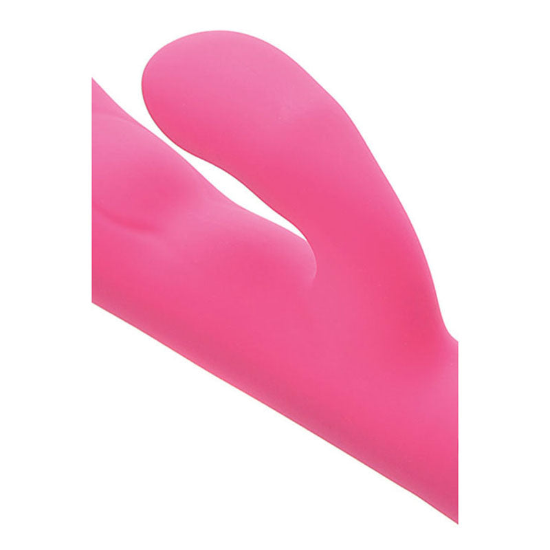 A close-up reveals the Adam & Eve The Warming Rabbit G, a pink, dual-pronged silicone vibrator with a smooth texture and curved design. It features a G-Spot tip and offers dual stimulation against a white background.