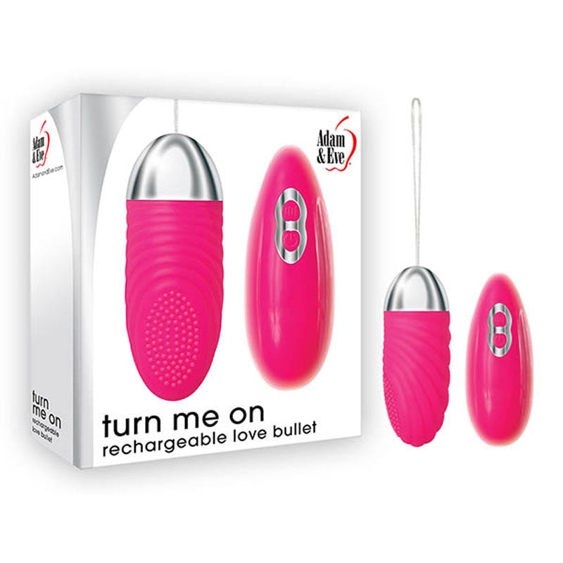 A pink Adam & Eve Turn Me On Rechargeable Love Bullet (8.9 cm) with a metallic tip is shown alongside its packaging, which features the text turn me on rechargeable love bullet. Made from body-safe silicone, it has a control button and the brand name on the box.