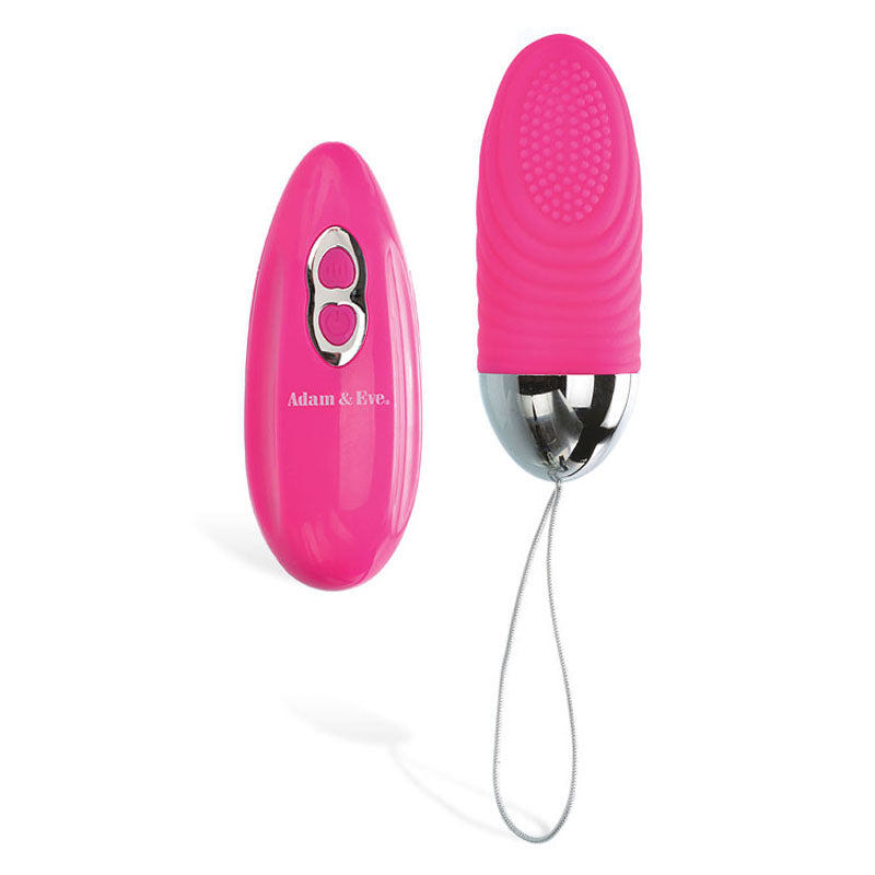 The Adam & Eve Turn Me On Rechargeable Love Bullet features a pink, body-safe silicone massager with a silver base and retrieval cord. It includes a matching wireless remote with two buttons and silver accents, ideal for easy control. The bullets end is textured for enhanced sensation.