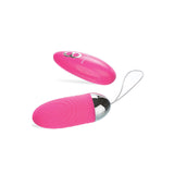 The Adam & Eve Turn Me On Rechargeable Love Bullet in pink, featuring a smooth metallic end and looped string, sits next to its two-button remote with an LED indicator. Made from body-safe silicone, both rest on a white background.