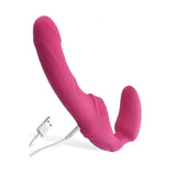 The Adam & Eve Eves Vibrating Strapless Strap-On in bright pink features curved silicone dual arms; the larger is wavy, while the smaller is smooth for enhanced vibration. It includes a side control button and a white USB charging cable for convenient recharging.