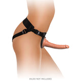 A person in side view wears the King Cock Elite Comfy Body Dock Strap-On Harness with adjustable waist and thigh straps. A realistic skin-tone dildo is attached. The text DILDO NOT INCLUDED appears on a white background.