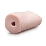 A beige cylindrical EnLust - Alyssa stroker, made from ultra-soft material, has a small central opening and a textured band near the edge. The smooth surface of this male pleasure toy is angled with the opening facing slightly towards the viewer.