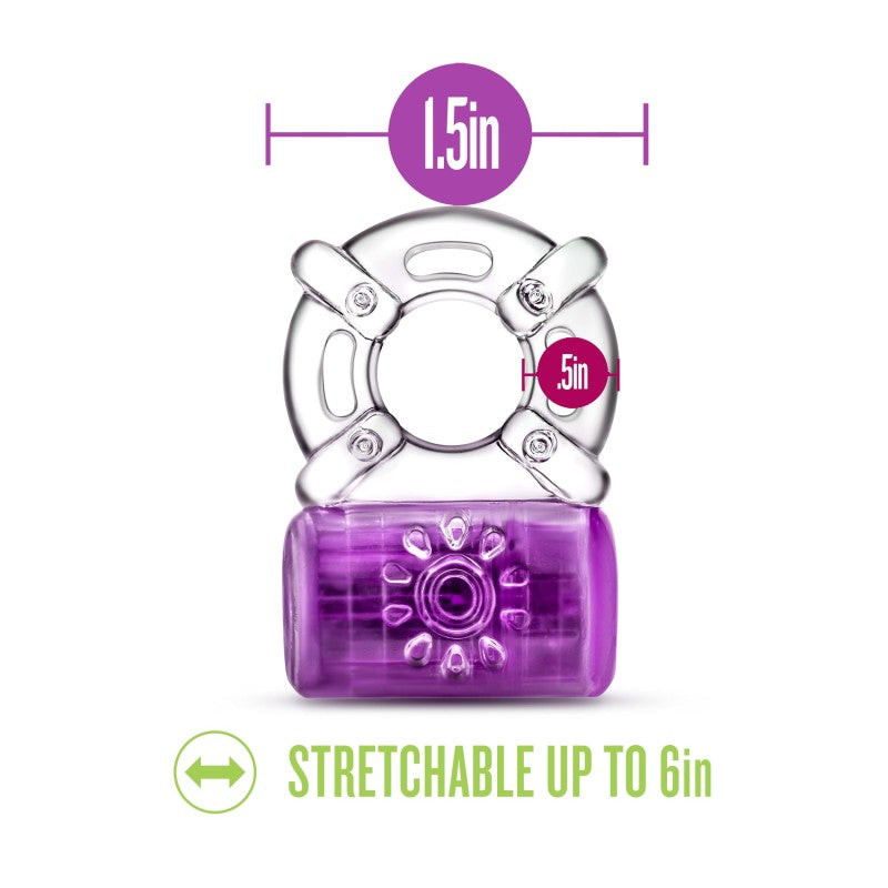 The Play With Me Pleaser Rechargeable C-Ring in purple features a striking cylindrical flower-patterned section and a clear part with four loops. It measures 1.5 inches in diameter, stretches to 6 inches, offers powerful vibrations, and is USB rechargeable for endless fun.