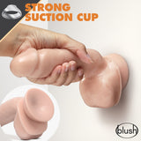 A hand holds the Dr. Skin Glide 8.5 Inch Self Lubricating Dildo in flesh tone against a white wall, showcasing the realistic design and strong suction cup feature. An inset zooms in on the base with Strong Suction Cup displayed above. Branding reads blush.