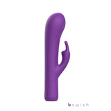 The Bwild Bunny Infinite Deluxe, a 19.3 cm purple USB rechargeable rabbit vibrator, features a smooth main shaft and flexible smaller shaft for dual-stimulation. Its minimalist design is accented with B Swish in lowercase at the base, presented elegantly on a plain white backdrop.