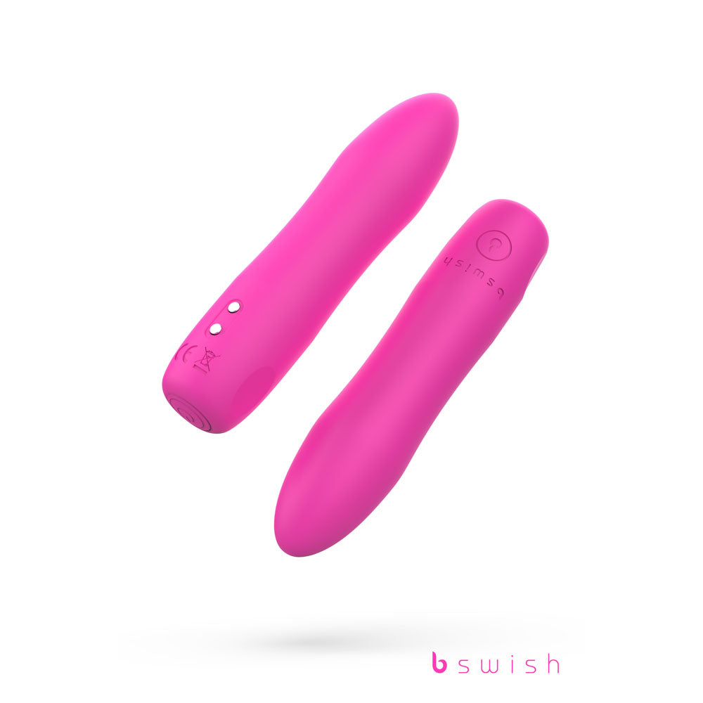 The Bcute Infinite Heat Classic Vibrator in Sunset Pink, featuring a smooth cylindrical design with a rounded tip, displays an embossed logo near the two buttons and charging port on one side. This 10 cm, USB rechargeable silicone massager by bswish is set against a white background.