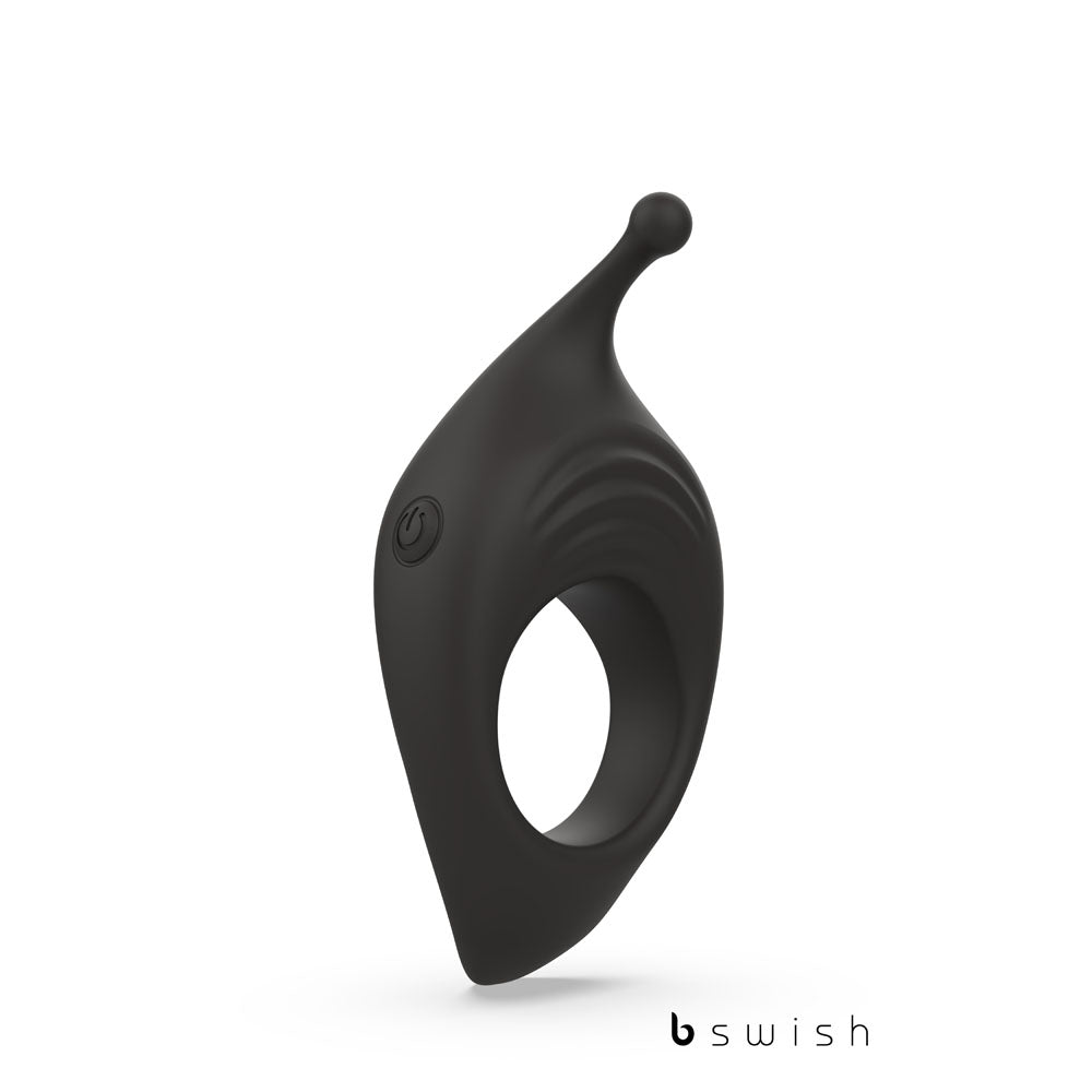 Meet the BCharmed Rhythm Infinite Deluxe—Black: a silicone vibrating cock ring with a curved design, small extending tip, 15 vibration modes, side power button, and textured surface. The bswish logo is prominently displayed against a sleek white background. USB rechargeable for endless pleasure.