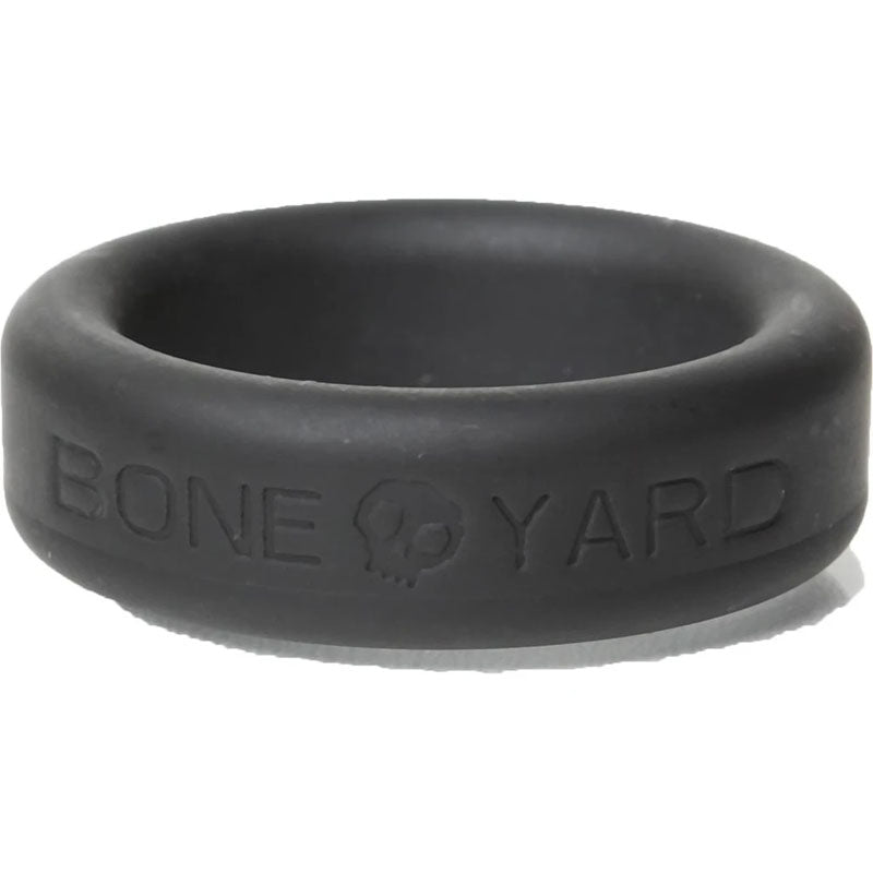 The Boneyard Silicone Ring 30mm - Black features BONEYARD with a skull symbol between BONE and YARD. Crafted from durable 3x-stretch material, its matte texture contrasts beautifully against a white backdrop, perfect for man toys enthusiasts.