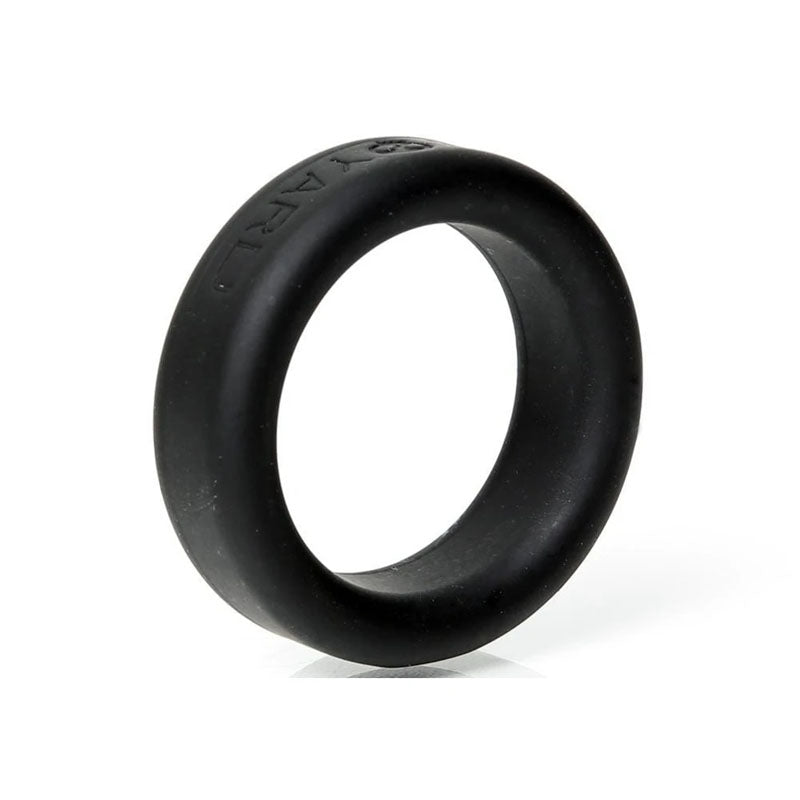 The Boneyard Silicone Ring 30mm - Black offers a stylish and functional blend with its smooth, matte finish and slightly rounded design. This 3x-stretch cock ring features subtle embossed text, stands upright on a reflective surface, and casts a soft shadow below—ideal among man toys.