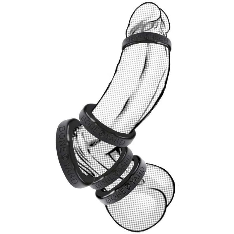 An illustration depicts a phallic shape with a black grid pattern, featuring five evenly spaced Boneyard Silicone Ring 50mm - Black cock rings known for their 3x-stretch capability, suggesting use on similar toys, against a plain white background.