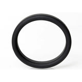 The Boneyard Silicone Ring 50mm - Black stands upright on a white background, showcasing its smooth texture and uniform width. With 3x-stretch capabilities, this modern 50 mm cock rings versatile design is highlighted under strategic lighting.