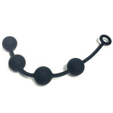 The Boneyard Ass Ballz M - Black 40 cm features medium anal balls made from hypoallergenic, soft-touch silicone. Designed with four beads of increasing size on a flexible strand and a loop handle for easy grip, they are evenly spaced and slightly curved for comfortable personal use.