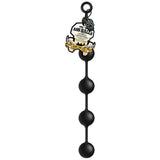 The Boneyard Ass Ballz L - Black 46 cm features soft-touch black silicone anal beads with four decreasingly sized round beads and a circular loop at the top for easy handling. A product tag shows branding and decorative elements partially visible.