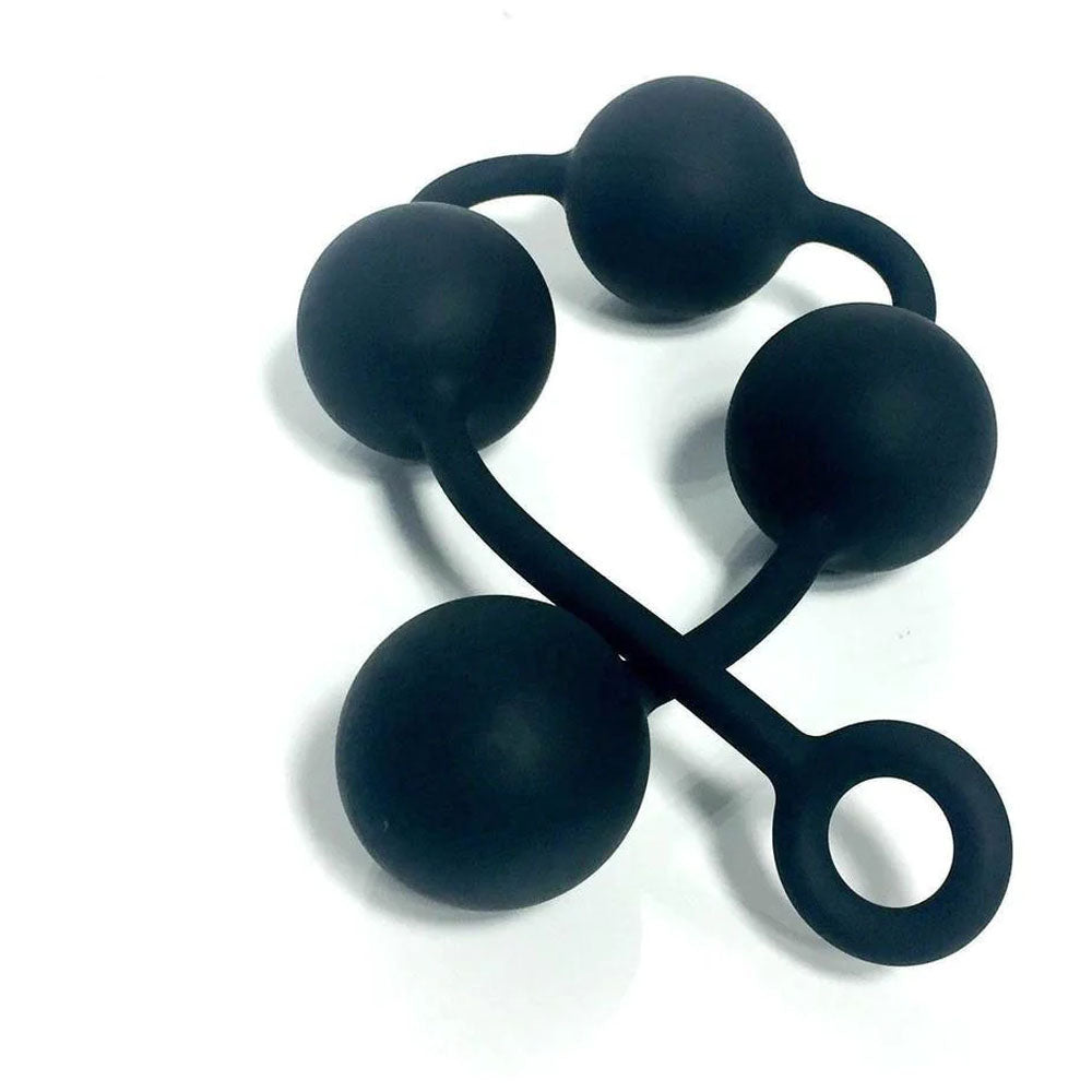 Four black, medical-grade silicone Boneyard Ass Ballz L are connected by a flexible strip with a loop handle, shown on a white background. The smooth finish accentuates their symmetrical layout and uniform texture.