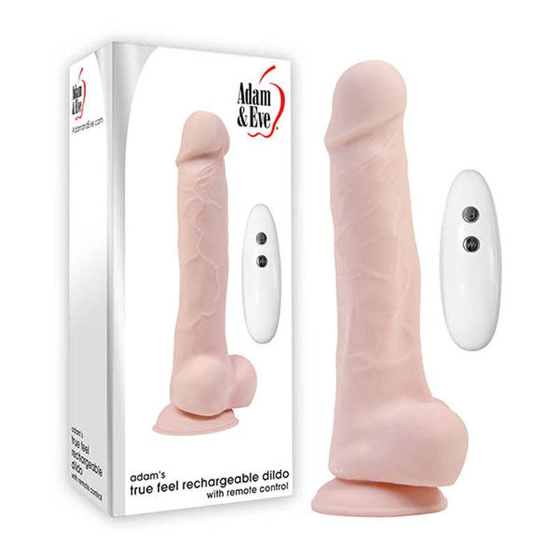 A realistic vibrating dildo with a suction cup base is shown next to a two-button remote and its packaging. The box, featuring the Adam & Eve logo, displays Adam & Eve Adams True Feel Rechargeable Dildo - Flesh 17.8 cm, made with True Feel TPE for realism.