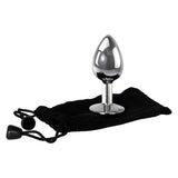 The Adam & Eve Clear Gem Anal Plug - Small features a polished aluminum finish with a tapered shape and clear gem base, positioned upright on a black drawstring pouch. Its reflective surface enhances allure for temperature play.