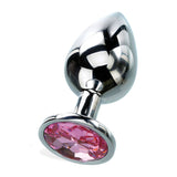 The Adam & Eve Medium Silver Metal Anal Plug is crafted from polished aluminum with a sleek, bulbous shape narrowing to a stem. It features a large round pink gem at its base, reflecting light and highlighting its smooth texture and modern design. Total length: 8.2 cm.