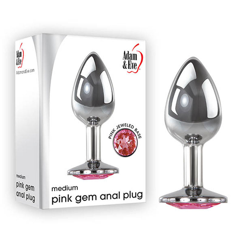 Image of a polished aluminum butt plug with a reflective surface, featuring a pink jeweled base. Next to its packaging, which also shows the image and Adam & Eve brand. The box reads Adam & Eve Pink Gem Anal Plug - Medium - Silver Medium 8.2 cm Metal Butt Plug with Pink Gem on a white background.