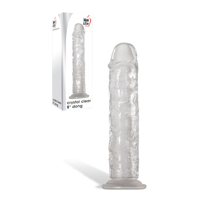 A lifelike, transparent 20.3 cm silicone dildo with a rounded tip and textured veins stands beside its packaging. The box features a product image, Adam & Eve Crystal Clear 8 Dong text, and the Man Zone logo. This realistic dong includes a flared suction cup base on a white background.