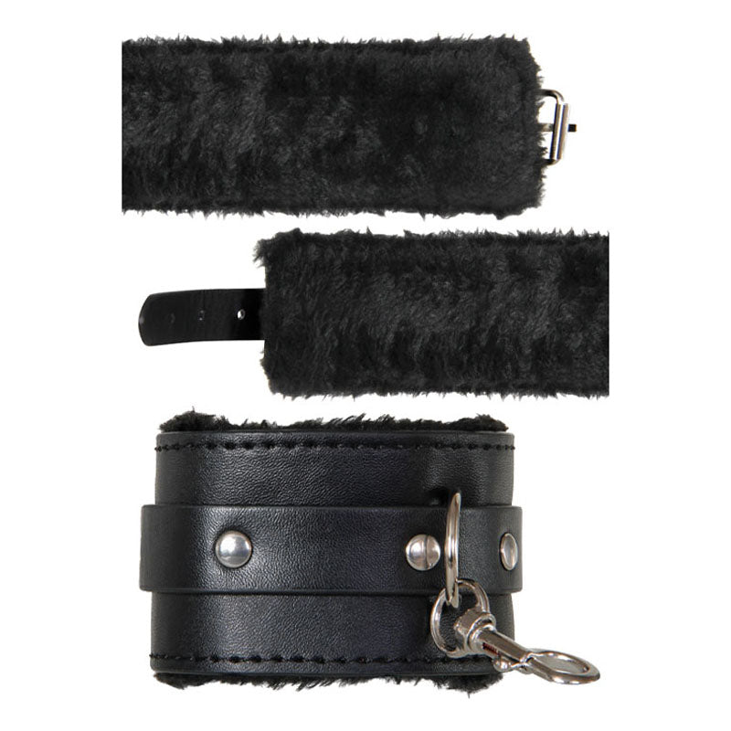 The Adam & Eve Hog Tie in black vegan leather combines silver-studded style and comfort with soft faux fur lining, featuring an open cuff with a buckle strap on top and a closed cuff with an attached metal clip for secure bondage play.