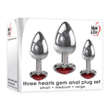 Introducing the Adam & Eve Three Hearts Gem Anal Plug Set with metallic butt plugs perfect for anal training. Each plug features a red jeweled heart base, available in small to large sizes, creating an elegant contrast against the white backdrop that highlights both product and brand details.