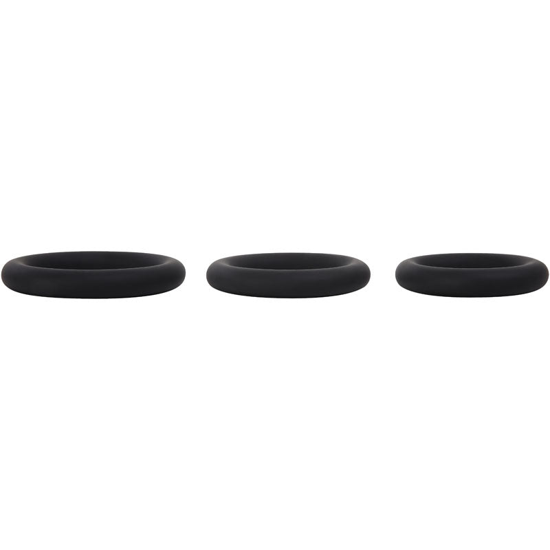 The Adam & Eve Silicone Penis Ring Set features three black cock rings arranged horizontally against a white background. Each ring has a smooth texture and rounded shape, ideal for prolonging erections.